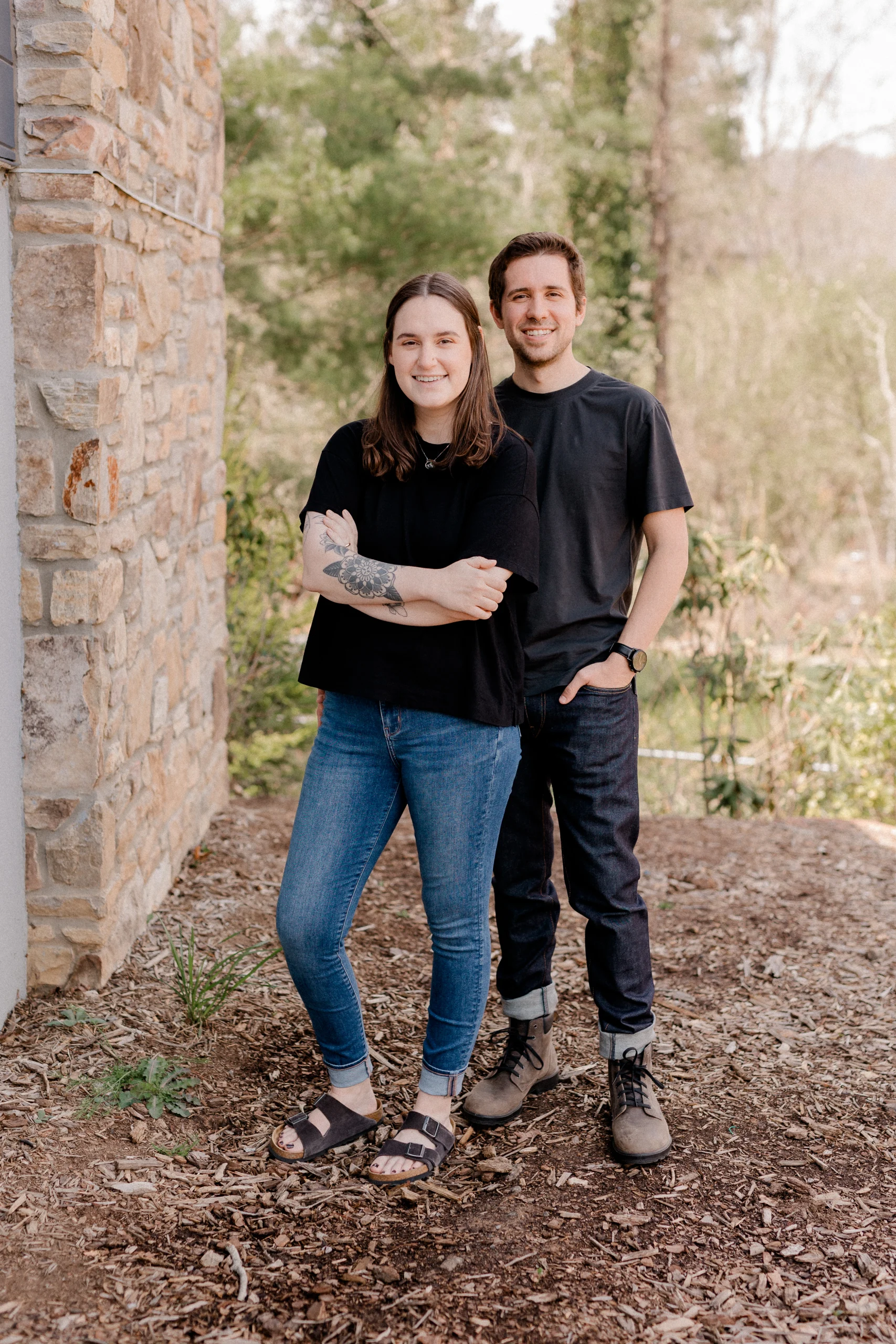 Co-owners of Barefoot Build stand outside smiling