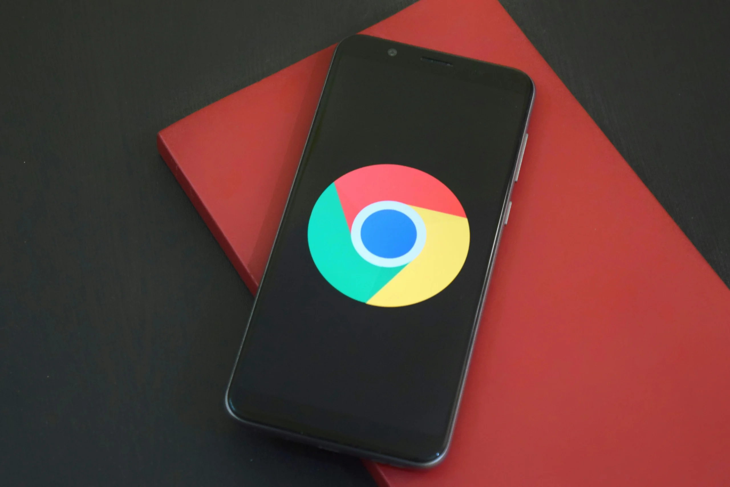 pexels-deepanker70-1482061 Phone opened to Google App situated on a red book
